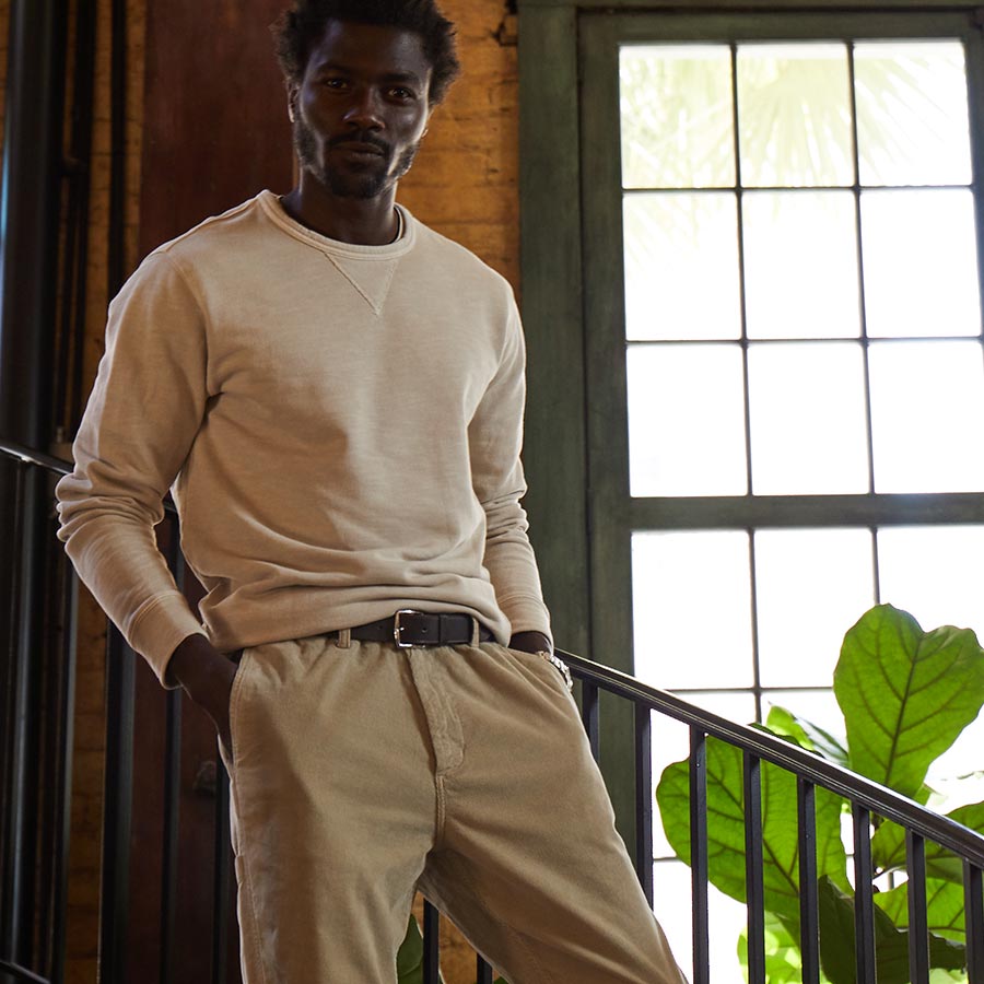 man wearing an outfit by oobe brand standing on stairs