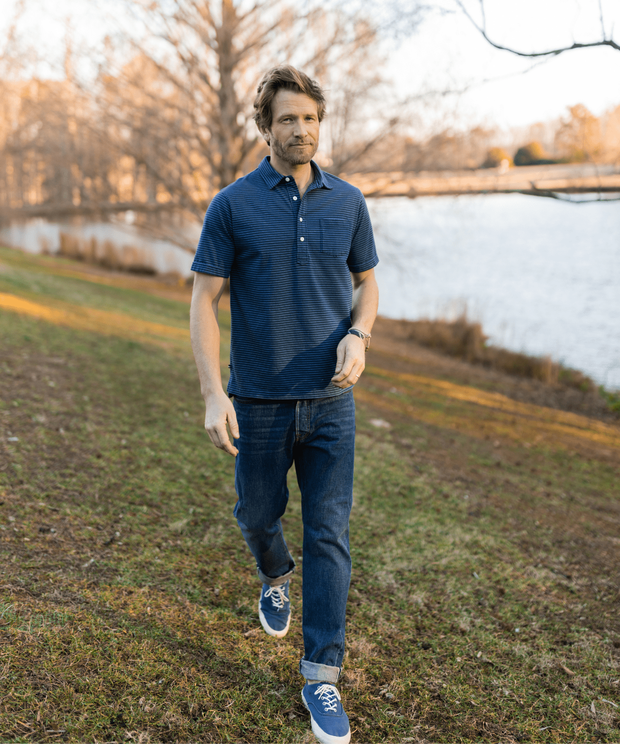 man wearing a blue striped polo shirt by oobe brand