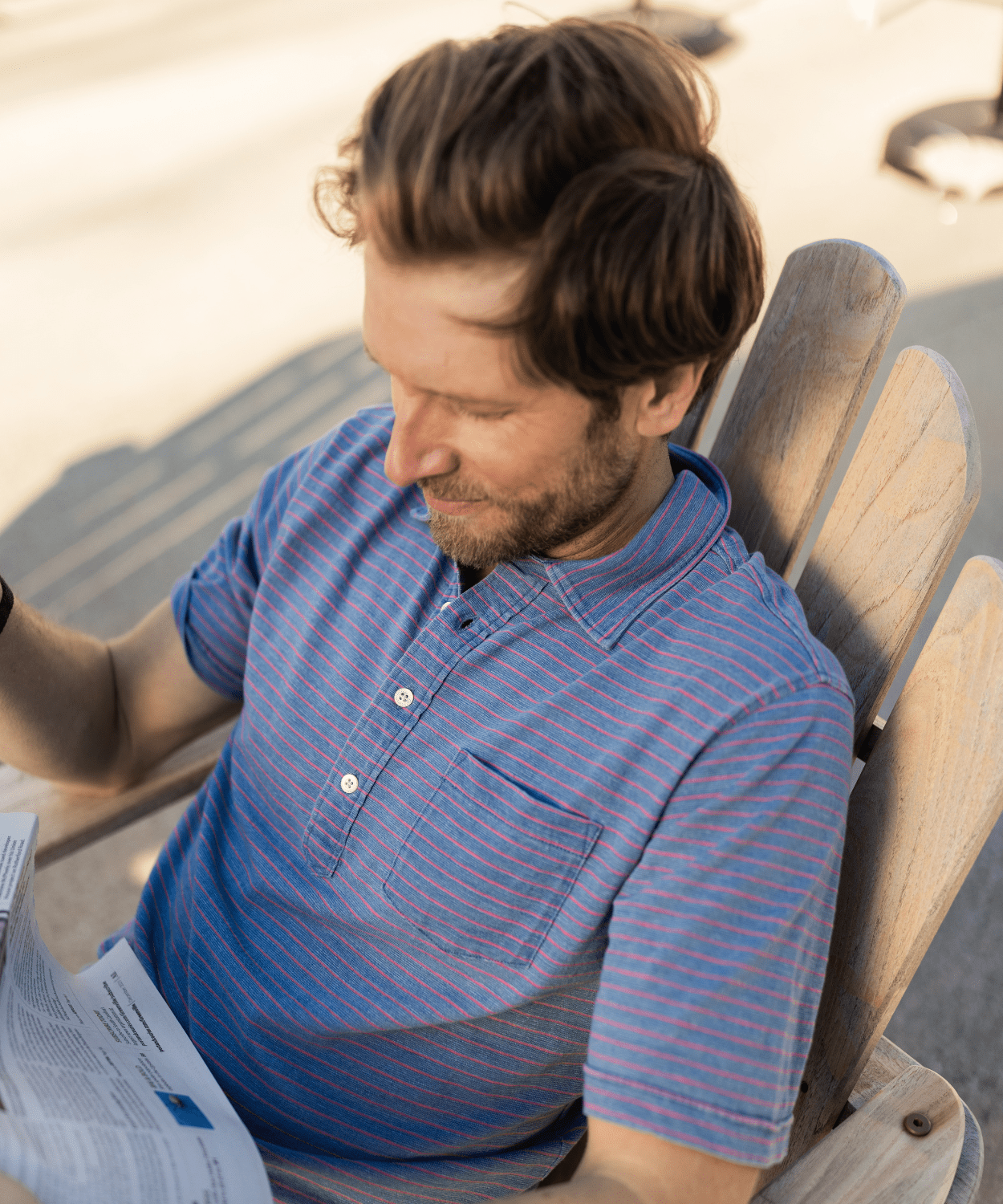 man wearing an indigo blue cotton striped polo shirt by oobe brand