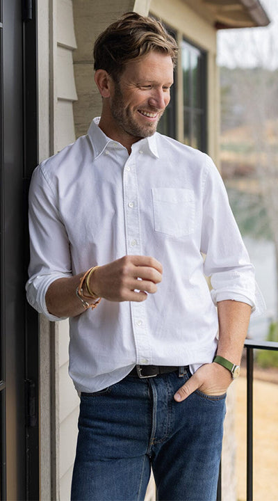 A man wearing OOBE Brand Anson Oxford Shirt partially tucked in Jeans.