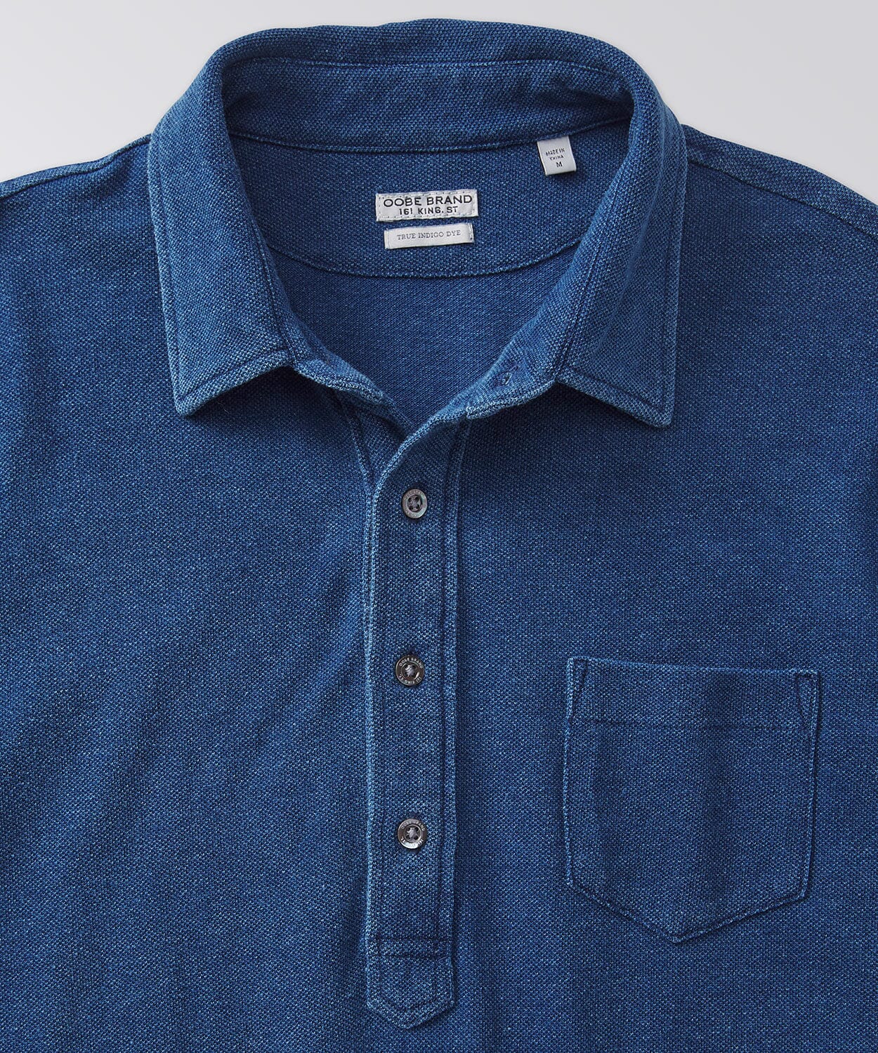 front of a blue polo