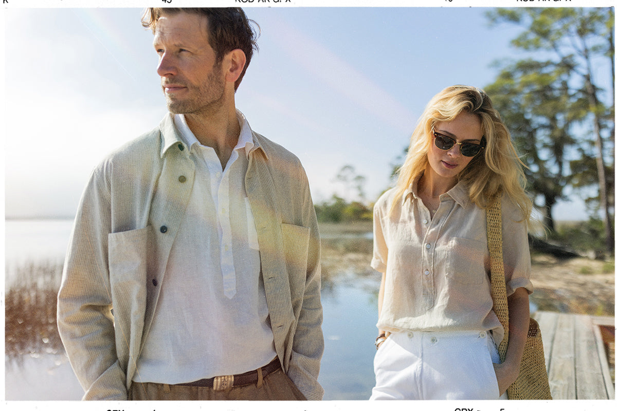 man and a woman standing beside a marsh
