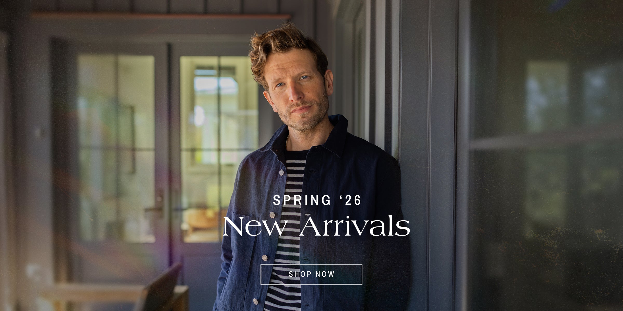 man in a jacket and striped shirt