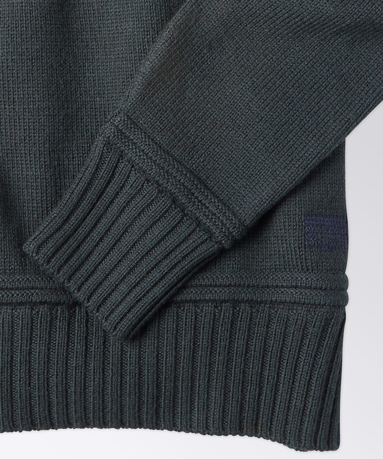 sleeve of a mens sweater with a C